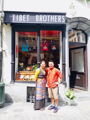 TibetBrothers founders standing in front of the Brussels storefront